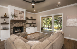 Comfortable living area with couch, brick fireplace, and built-in shelving.