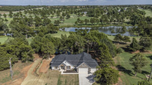 Drone footage of a custom home with a lake in the background