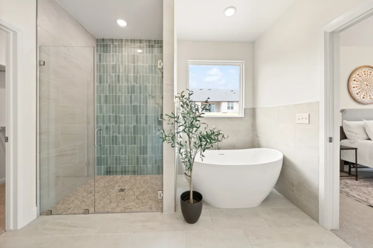 new construction bathroom with blue tile and freestanding tub