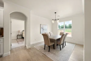 new construction dining room with window view and chandelier