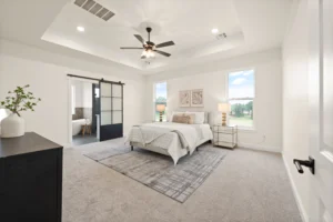 New construction primary bedroom with barn door